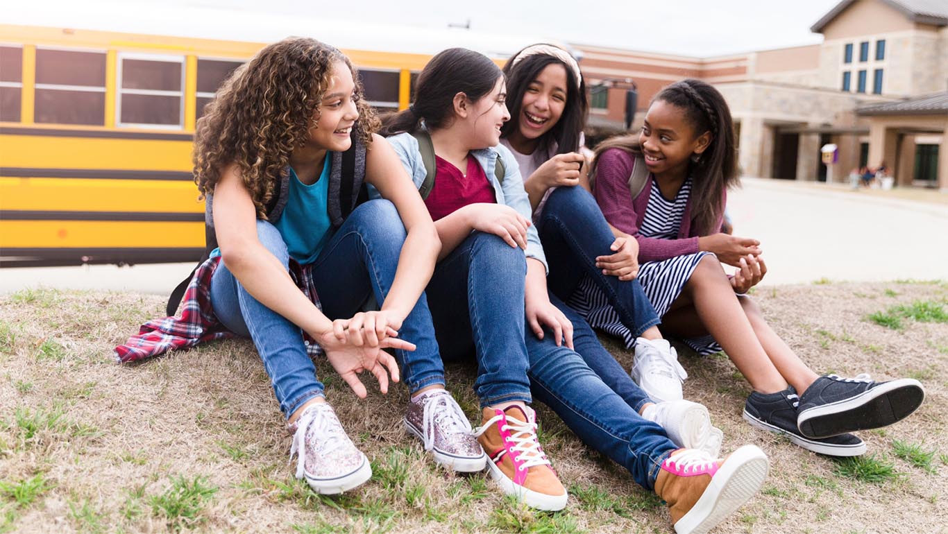 Four teenage girls interacting